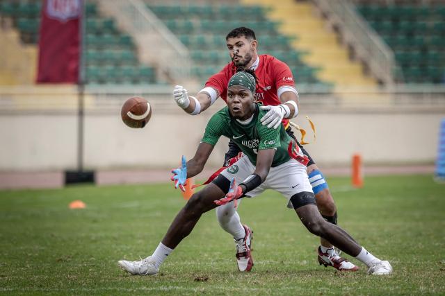 A player of Nigeria’s national men’s senior flag football team competes for the ball with a player from Egypt during their game at the NFL Flag Africa Continental Championships at Nyayo Stadium in Nairobi on July 10, 2026. American Football's NFL came to Kenya this weekend for its latest competition on the African continent as it seeks to win converts to the sport. US sports have increasingly sought to break into the African market, with the NBA launching a high-profile Basketball Africa League in 2019, based in Rwanda.Recent days saw a third annual flag football competition staged by the National Football League (NFL) in Africa -- a non-contact version of the sport that has grown in popularity around the world and will make its Olympics debut at the 2028 Los Angeles Games. (Photo by Luis TATO / AFP)