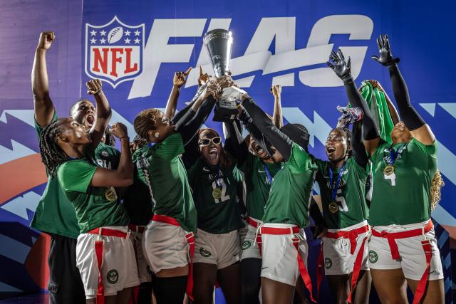 TOPSHOT - Players of Nigeria’s national women’s senior flag football team lift the trophy as they celebrate their tournament victory during the NFL Flag Africa Continental Championships at Nyayo Stadium in Nairobi on July 10, 2026. American Football's NFL came to Kenya this weekend for its latest competition on the African continent as it seeks to win converts to the sport. US sports have increasingly sought to break into the African market, with the NBA launching a high-profile Basketball Africa League in 2019, based in Rwanda.Recent days saw a third annual flag football competition staged by the National Football League (NFL) in Africa -- a non-contact version of the sport that has grown in popularity around the world and will make its Olympics debut at the 2028 Los Angeles Games. (Photo by Luis TATO / AFP)