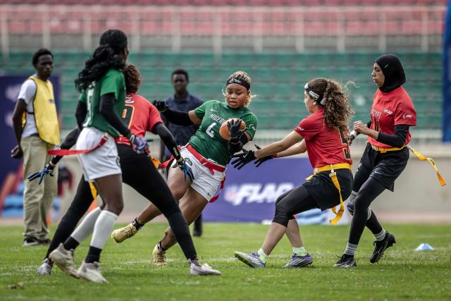 A player of Nigeria’s national women’s senior flag football team runs with the ball to score a touchdown against Egypt during the NFL Flag Africa Continental Championships at Nyayo Stadium in Nairobi on July 10, 2026. American Football's NFL came to Kenya this weekend for its latest competition on the African continent as it seeks to win converts to the sport. US sports have increasingly sought to break into the African market, with the NBA launching a high-profile Basketball Africa League in 2019, based in Rwanda.Recent days saw a third annual flag football competition staged by the National Football League (NFL) in Africa -- a non-contact version of the sport that has grown in popularity around the world and will make its Olympics debut at the 2028 Los Angeles Games. (Photo by Luis TATO / AFP)
