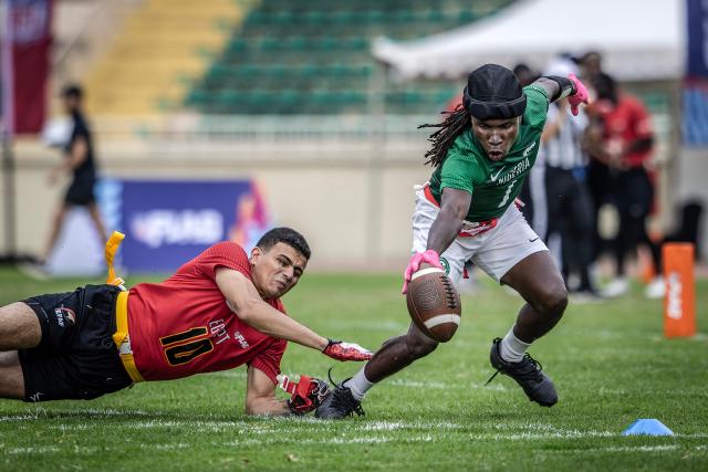 TOPSHOT - A player of Nigeria’s national men’s senior flag football team attempts to score a touchdown as an Egypt player pulls his flag during their game at the NFL Flag Africa Continental Championships at Nyayo Stadium in Nairobi on July 10, 2026. American Football's NFL came to Kenya this weekend for its latest competition on the African continent as it seeks to win converts to the sport. US sports have increasingly sought to break into the African market, with the NBA launching a high-profile Basketball Africa League in 2019, based in Rwanda.Recent days saw a third annual flag football competition staged by the National Football League (NFL) in Africa -- a non-contact version of the sport that has grown in popularity around the world and will make its Olympics debut at the 2028 Los Angeles Games. (Photo by Luis TATO / AFP)