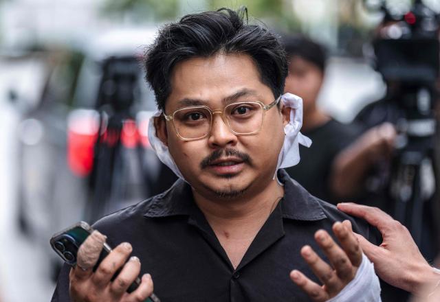 Athipat "Ice" Wijarn, whose band 'Tossakan' was performing when a fire broke out at the Rong Beer Na Lat Phrao bar, speaks to the media in Bangkok on July 13, 2026. A huge fire in a Bangkok bar killed at least 27 people and injured dozens, officials and witnesses said on July 13, the deadliest such incident in Thailand for almost two decades. (Photo by Chanakarn LAOSARAKHAM / AFP)