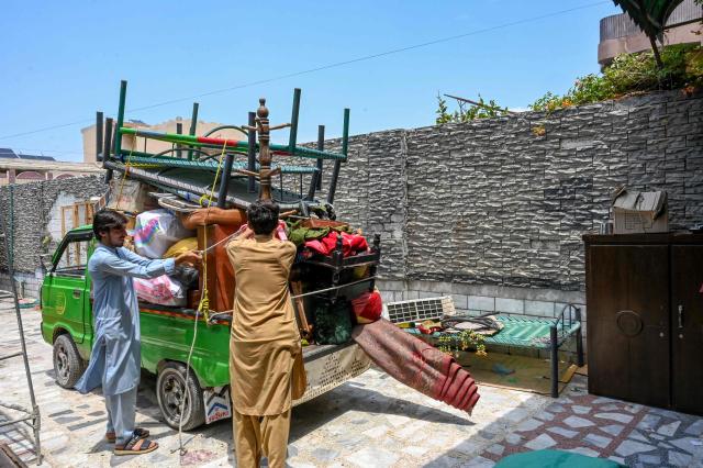 Afghan refugees load their belongings onto a truck in Peshawar on July 13, 2026, as they prepare to depart for Afghanistan. (Photo by Abdul MAJEED / AFP)