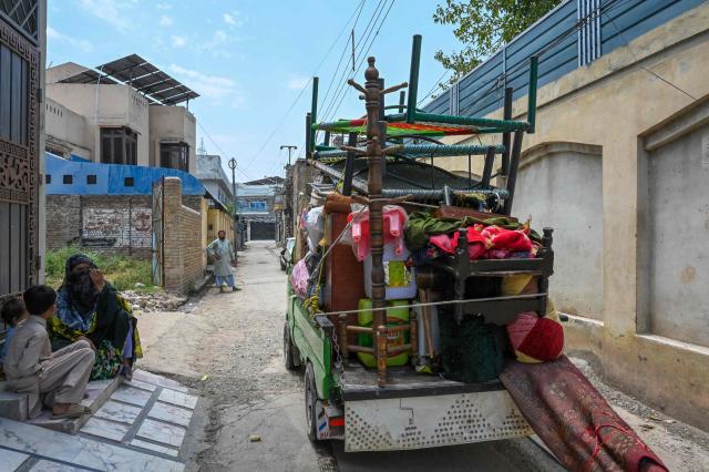 Afghan refugees vacate their houses in Peshawar on July 13, 2026, as they prepare to depart for Afghanistan. (Photo by Abdul MAJEED / AFP)