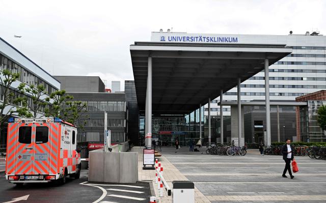(FILES) An ambulance car arrives at the university hospital (Universitätsklinikum Frankfurt) in Frankfurt am Main, western Germany, on May 11, 2026. Less than two months after the arrival of the first US Ebola patient from the Democratic Republic of the Congo, a second patient has been brought to Germany. According to the Federal Ministry of Health, the patient was admitted to the university hospital in Frankfurt am Main on July 13, 2026. He is being treated in "complete isolation" in the special isolation unit there. Consequently, there is "no risk whatsoever" to the general public or to other patients. (Photo by Kirill KUDRYAVTSEV / AFP)