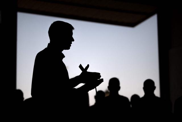 Spain's Prime Minister Pedro Sanchez silhouetted as he talks to media after a wildfire that killed at least 13 people, is pictured at the command post set in Turre, Almeria Province, on July 13, 2026. The toll from the deadly wildfires in southern Spain rose to 13 on July 12, 2026 after a British woman died of her injuries in hospital, officials in Andalusia region announced. (Photo by JORGE GUERRERO / AFP)