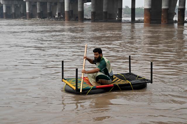 Relief personnel conduct a flood rescue drill during monsoon season as a precautionary measure at the Ravi river in Lahore on July 13, 2026. (Photo by Arif ALI / AFP)