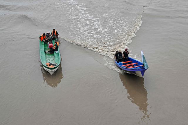 Relief personnel conduct a flood rescue drill during monsoon season as a precautionary measure at the Ravi river in Lahore on July 13, 2026. (Photo by Arif ALI / AFP)