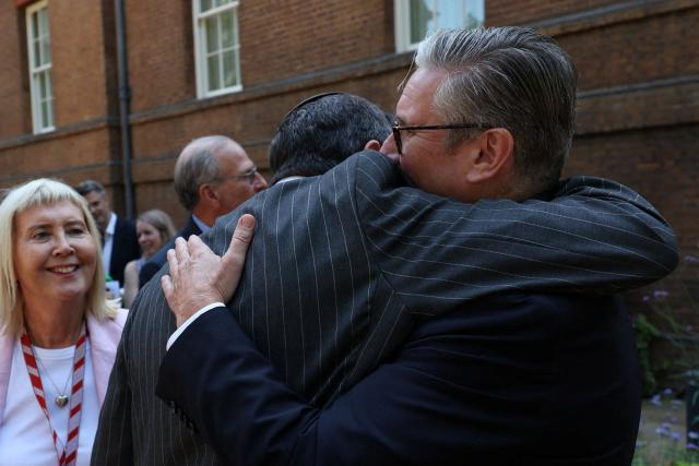 Britain's Prime Minister Keir Starmer (R) embraces a guest during a reception with members of the Jewish community to discuss efforts to tackle antisemitism, at 10 Downing Street, in London, on July 13, 2026. (Photo by Suzanne Plunkett / POOL / AFP)