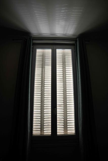 This photograph shows a view of sunrays passing through window blinds in Saint-Mandé, east of Paris, on July 13, 2026, amid a heatwave. The Paris region, and large parts of the rest of France, is currently experiencing the third heatwave since May 2026, increasing the risk of fires. The three heatwaves have seen temperature records broken in several countries across Europe and  have caused thousands of excess deaths, according to estimates in Belgium, Britain, France and Spain. (Photo by Martin LELIEVRE / AFP)