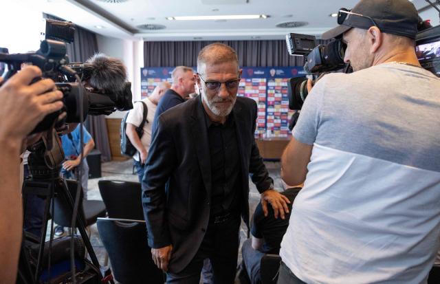 Former Croatian international defender Slaven Bilic leaves at the end of a press conference after being appointed Croatia's national football team head coach, in Zagreb on July 13, 2026. Slaven Bilic who previously coached Croatia between 2006 and 2012, is replacing Zlatko Dalic who resigned after the country's World Cup exit. The 57-year-old, who also coached English clubs West Ham, West Bromwich Albion and Watford, was "unanimously appointed" as head coach, the Croatian Football Federation (HNS) said. (Photo by Marko PERKOV / AFP)