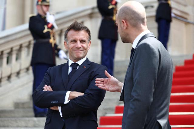 France's President Emmanuel Macron (L) and France's Foreign Affairs Minister Jean-Noel Barrot wait for the arrival of Ukrainian President for the Integrated Anti-Ballistic Missile Coalition meeting ahead of a summit of the Coalition of the Willing to support Ukraine at the Hotel des Invalides in Paris on July 13, 2026. The summit meeting of the Coalition of the Willing -- launched by France and the United Kingdom to provide military support to Ukraine after Russia's full-scale invasion -- will push for a ceasefire and renewed peace talks, the French presidency said. (Photo by Tom Nicholson / POOL / AFP)