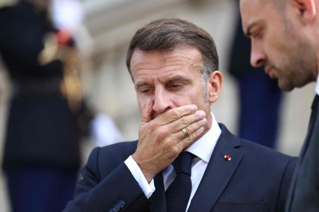 France's President Emmanuel Macron and France's Foreign Affairs Minister Jean-Noel Barrot wait for the arrival of Ukrainian President for the Integrated Anti-Ballistic Missile Coalition meeting ahead of a summit of the Coalition of the Willing to support Ukraine at the Hotel des Invalides in Paris on July 13, 2026. The summit meeting of the Coalition of the Willing -- launched by France and the United Kingdom to provide military support to Ukraine after Russia's full-scale invasion -- will push for a ceasefire and renewed peace talks, the French presidency said. (Photo by Tom Nicholson / POOL / AFP)