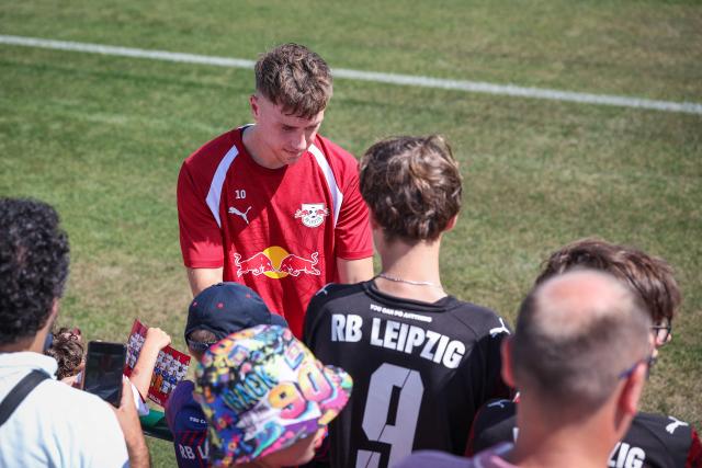Leipzig's German midfielder #10 Brajan Gruda signs autographs for fans after a training at the training grounds of German first division Bundesliga football club RB Leipzig in Leipzig, eastern Germany on July 13, 2026. (Photo by Ronny HARTMANN / AFP)