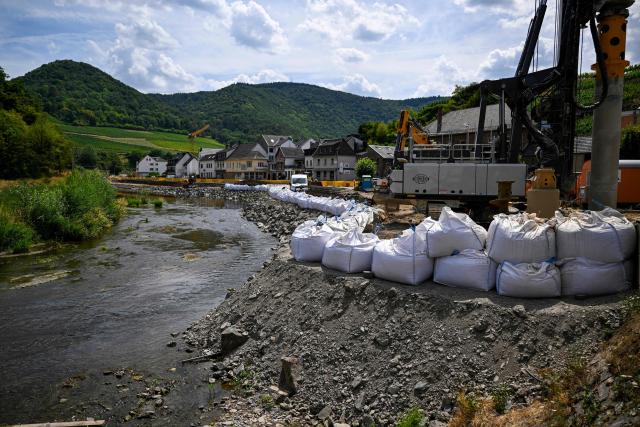 Construction work involving sandbags continues on the banks of the Ahr river in Mayschoss, western Germany, on July 13, 2026, five years after the dramatic floods of July 14 and 15, 2021 in Rhineland-Palatinate and North Rhine-Westphalia. More than 180 people lost their lives in severe floods that pummelled western Germany in mid-July 2021, raising questions about whether enough was done to forewarn residents. (Photo by Ina FASSBENDER / AFP)