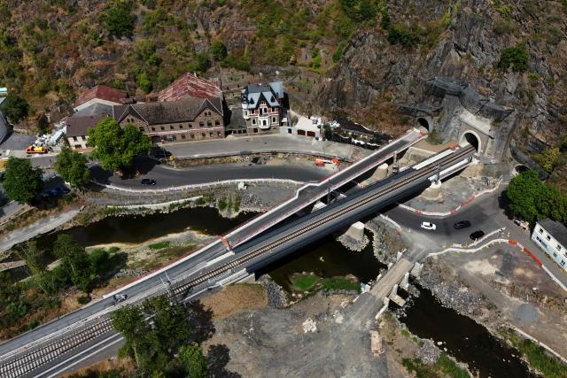An aerial view shows the newly built railway line near the Ahr river in Altenahr, western Germany, on July 13, 2026, five years after the dramatic floods of July 14 and 15, 2021 in Rhineland-Palatinate and North Rhine-Westphalia. More than 180 people lost their lives in severe floods that pummelled western Germany in mid-July 2021, raising questions about whether enough was done to forewarn residents. (Photo by Ina FASSBENDER / AFP)