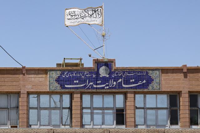 The Taliban flag flutters over the Government Office building in Herat on July 13, 2026. Afghanistan's minister in charge of vice and virtue defended on July 13, the crackdown on women's dress code in the western city of Herat, saying it protected "dignity" and dismissing criticism as propaganda. (Photo by Mohsen KARIMI / AFP) / ALTERNATIVE CROP