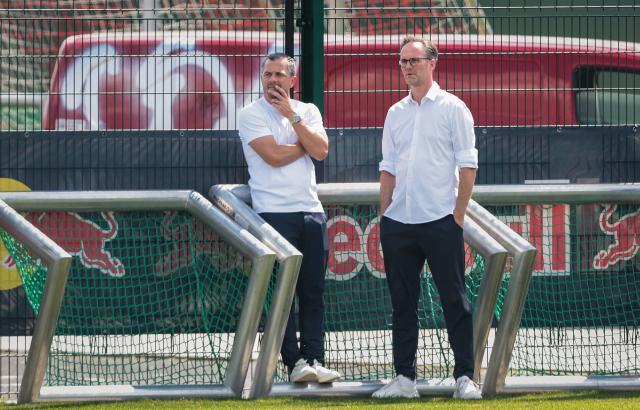 RB Leipzig's sporting director Marcel Schaefer (L) and RB Leipzig's Head of Global Soccer Commercial Florian Scholz (R) oversee a training session at the training grounds of German first division Bundesliga football club RB Leipzig in Leipzig, eastern Germany on July 13, 2026. (Photo by Ronny HARTMANN / AFP)