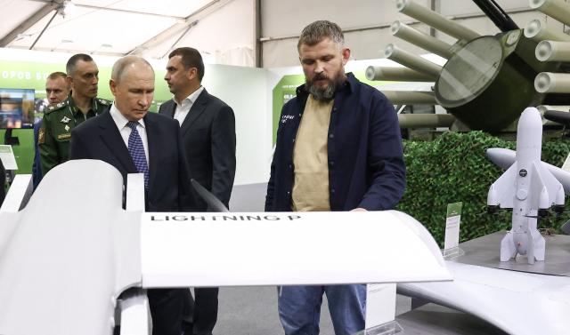 In this pool photograph distributed by the Russian state agency Sputnik, Russia's President Vladimir Putin tours an exhibition of the Everything for the Victory patriotic forum in Moscow on July 13, 2026. (Photo by Artem Geodakyan / POOL / AFP)