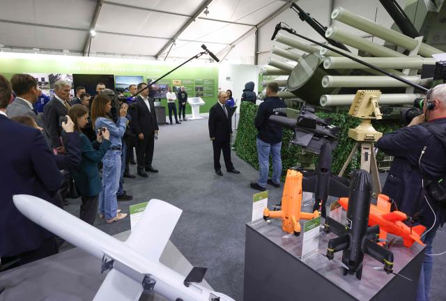 In this pool photograph distributed by the Russian state agency Sputnik, Russia's President Vladimir Putin tours an exhibition of the Everything for the Victory patriotic forum in Moscow on July 13, 2026. (Photo by Artem Geodakyan / POOL / AFP)