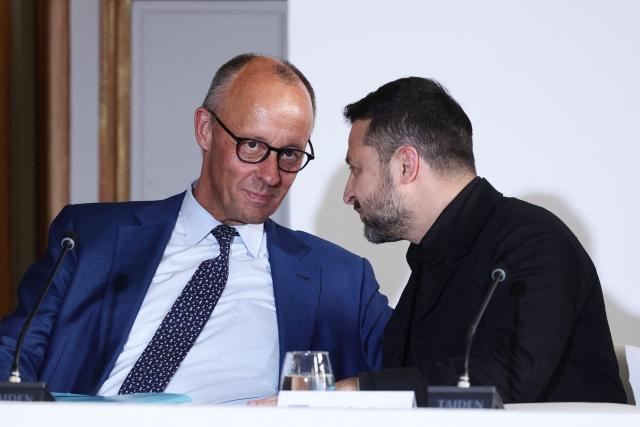 Ukraine's President Volodymyr Zelensky (R) and Germany's Chancellor Friedrich Merz take part in a summit of the Coalition of the Willing to support Ukraine at the Hotel des Invalides in Paris on July 13, 2026. The summit meeting of the Coalition of the Willing -- launched by France and the United Kingdom to provide military support to Ukraine after Russia's full-scale invasion -- will push for a ceasefire and renewed peace talks, the French presidency said. (Photo by Teresa Suarez / POOL / AFP)