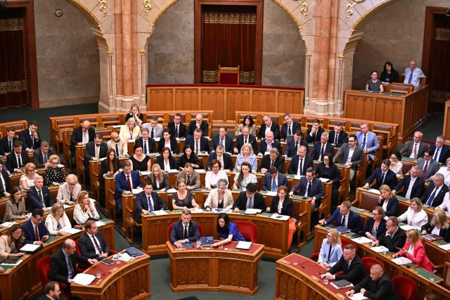 Lawmakers including Hungarian Prime Minister Peter Magyar (first row, centre L) and Foreign Minister Anita Orban (R) vote on a constitutional amendment at the extraordinary session of parliament at the House of Representatives in Budapest, Hungary on July 13, 2026. The Hungarian parliament on on July 13, 2026 passed a constitutional tweak to oust the country's president, whom new Prime Minister Peter Magyar accuses of being a "puppet" of hardline ex-leader Viktor Orban. Lawmakers from Magyar's Tisza party broke into a half-minute-long standing ovation after voting to eject unpopular President Tamas Sulyok from office by 139 votes to six, in a ballot boycotted by Orban's nationalist Fidesz party. (Photo by Attila KISBENEDEK / AFP)