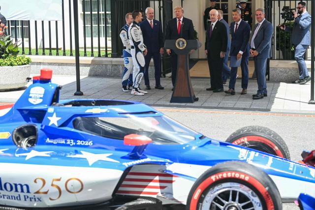 US President Donald Trump looks at an Indy car during a Freedom 250 Grand Prix Showcase outside the White House in Washington, DC, on July 13, 2026. The Freedom 250 Grand Prix race will be the fifteenth round of the 2026 IndyCar Series, taking place on August 22-23 in Washington, DC. (Photo by SAUL LOEB / AFP)