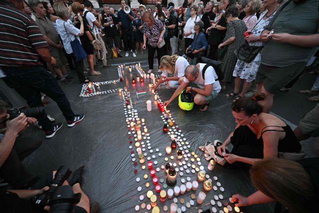Supporters of the former ruling party, FIDESZ, protest the amendment to the Fundamental Law with a candlelight at Kossuth Lajos Square, in front of the parliament building in Budapest, Hungary on July 13, 2026. The Hungarian parliament on on July 13, 2026 passed a constitutional tweak to oust the country's president, whom new Prime Minister Peter Magyar accuses of being a "puppet" of hardline ex-leader Viktor Orban. Lawmakers from Magyar's Tisza party broke into a half-minute-long standing ovation after voting to eject unpopular President Tamas Sulyok from office by 139 votes to six, in a ballot boycotted by Orban's nationalist Fidesz party. (Photo by Attila KISBENEDEK / AFP)