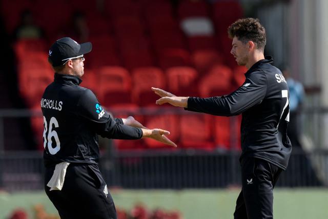 Mitchell Santner (R) and Henry Nicholls (L) of New Zealand celebrates the dismissal of John Campbell (unseen) of West Indies during second one-day international (ODI) cricket match between West Indies and New Zealand at Guyana National Stadium in Providence, Guyana on July 13, 2026. (Photo by Randy Brooks / AFP)