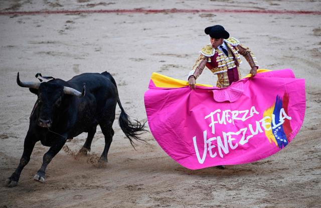 Venezuelan Jose Enrique Colombo performs a pass to a Miura's fighting bull  during the corrida at the Plaza de Toros bullring in the San Fermin festival in Pamplona, northern Spain, on July 13, 2026. (Photo by ANDER GILLENEA / AFP)
