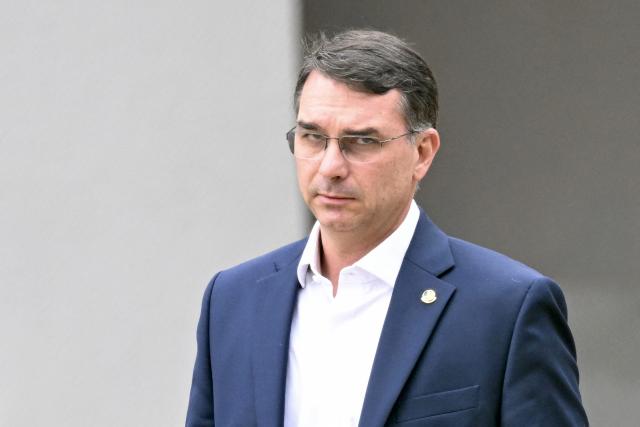 (FILES) Senator Flavio Bolsonaro, son of former Brazilian president Jair Bolsonaro, leaves the Federal Police headquarters where Bolsonaro is being held, in Brasilia, on November 25, 2025. Brazil's top court barred on July 13, 2026 presidential hopeful Flavio Bolsonaro from visiting his father, the former president Jair Bolsonaro, who is under house arrest, until after the first round of October elections. (Photo by Evaristo Sa / AFP)