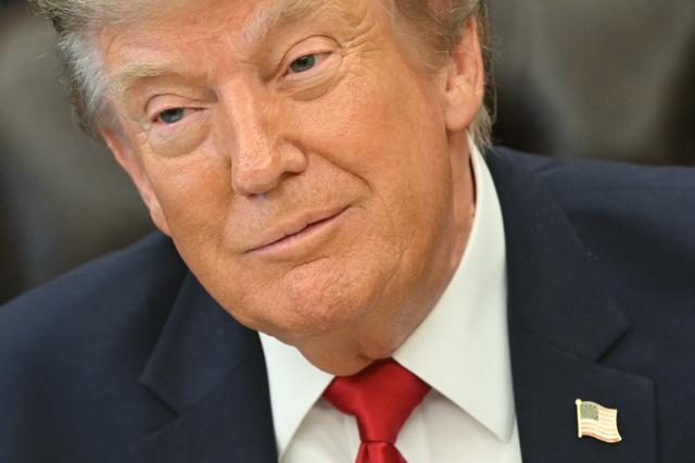 US President Donald Trump looks on before signing an executive order to drastically shrink two national monuments in Utah, paving the way for fossil fuel extraction and mining. (Photo by SAUL LOEB / AFP)