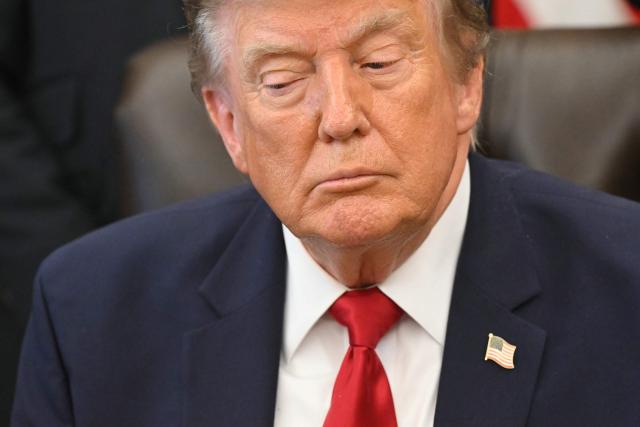 US President Donald Trump looks on after signing an executive order to drastically shrink two national monuments in Utah, paving the way for fossil fuel extraction and mining. (Photo by SAUL LOEB / AFP)