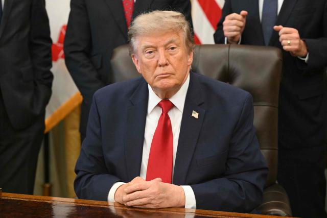 US President Donald Trump looks on after signing an executive order to drastically shrink two national monuments in Utah, paving the way for fossil fuel extraction and mining. (Photo by SAUL LOEB / AFP)