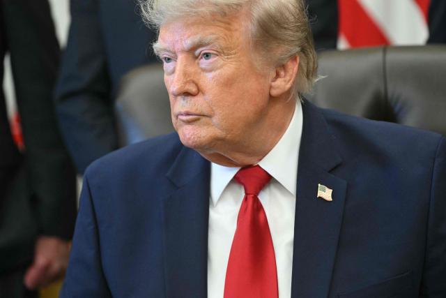 US President Donald Trump looks on after signing an executive order to drastically shrink two national monuments in Utah, paving the way for fossil fuel extraction and mining. (Photo by SAUL LOEB / AFP)