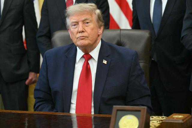 US President Donald Trump looks on after signing an executive order to drastically shrink two national monuments in Utah, paving the way for fossil fuel extraction and mining. (Photo by SAUL LOEB / AFP)