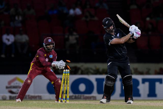 Daryl Mitchell (R) of New Zealand is dismissed by Shai Hope (L) of West Indies during the second one-day international (ODI) cricket match between West Indies and New Zealand at Guyana National Stadium in Providence, Guyana on July 13, 2026. (Photo by Randy Brooks / AFP)