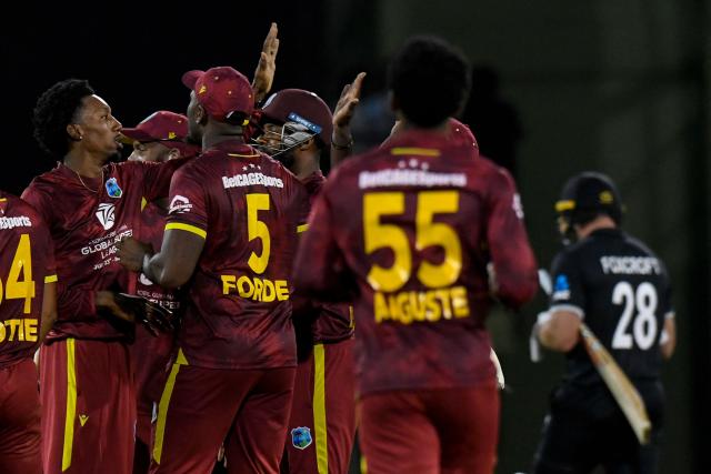 Khary Pierre (L) of West Indies celebrates the dismissal of Dean Foxcroft (R) of New Zealand during the second one-day international (ODI) cricket match between West Indies and New Zealand at Guyana National Stadium in Providence, Guyana on July 13, 2026. (Photo by Randy Brooks / AFP)