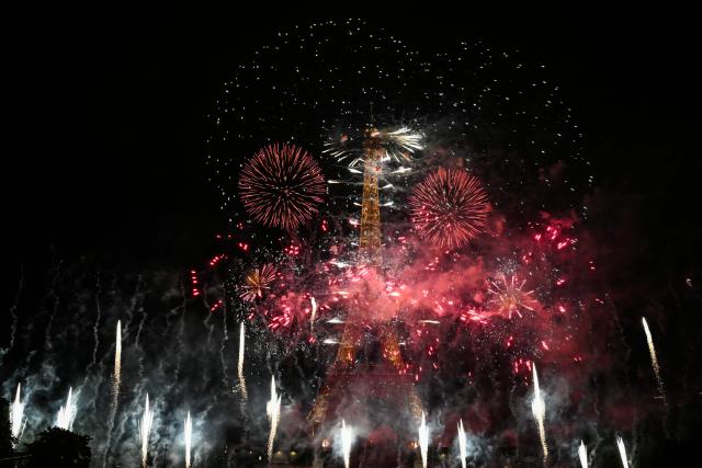 Fireworks light up the sky around the Eiffel Tower during a show marking Bastille Day in Paris on July 13, 2026, on the eve of the annual Bastille Day parade in the French capital. (Photo by LOU BENOIST / AFP)