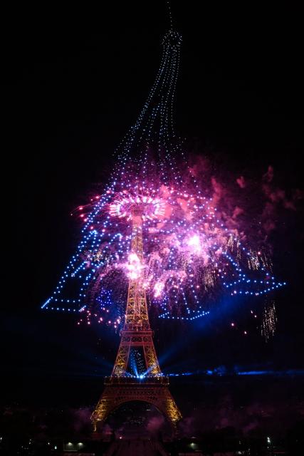 Fireworks and drones light up the sky around the Eiffel Tower during a choreographed show marking Bastille Day in Paris on July 13, 2026, on the eve of the annual Bastille Day parade in the French capital. (Photo by Lou BENOIST / AFP)