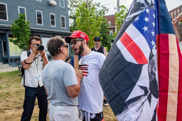 A supporter of US President Donald Trump and of ICE confronts a demonstrator at a vigil for Joan Sebastian Guerrero who was fatally shot during an Immigration and Customs Enforcement (ICE) operation in Biddeford, Maine, on July 13, 2026. A US immigration officer on July 13, fatally shot a man identified by rights groups as a 26-year-old Colombian, an incident likely to fuel criticism of President Donald Trump's deportation drive. The shooting happened in Biddeford, a town of 22,000 people in the northern state of Maine, and comes a week after an Immigration and Customs Enforcement (ICE) agent shot dead a Mexican man in Texas. (Photo by Joseph Prezioso / AFP)