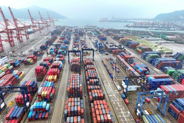 Containers are seen at the port in Lianyungang, in China’s eastern Jiangsu province on July 14, 2026. Chinese exports jumped more than a quarter last month, official data showed on July 14, providing a fresh boost to leaders as they look to kickstart growth in the world's second-largest economy. (Photo by CN-STR / AFP) / China OUT