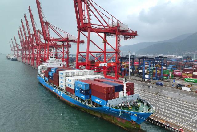 A container ship is seen at the port in Lianyungang, in China’s eastern Jiangsu province on July 14, 2026. Chinese exports jumped more than a quarter last month, official data showed on July 14, providing a fresh boost to leaders as they look to kickstart growth in the world's second-largest economy. (Photo by CN-STR / AFP) / China OUT