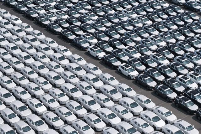 Chinese-made cars are seen before being loading for export at the vehicle export terminal in the port of Shanghai on July 14, 2026. Chinese exports jumped more than a quarter last month, official data showed on July 14, providing a fresh boost to leaders as they look to kickstart growth in the world's second-largest economy. (Photo by CN-STR / AFP) / China OUT