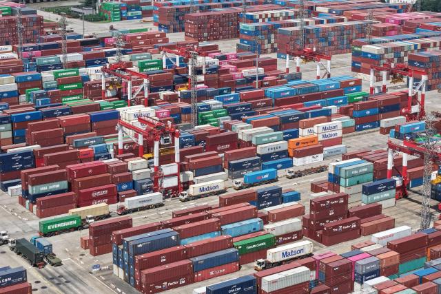 Containers are seen at the port in Shanghai on July 14, 2026. Chinese exports jumped more than a quarter last month, official data showed on July 14, providing a fresh boost to leaders as they look to kickstart growth in the world's second-largest economy. (Photo by CN-STR / AFP) / China OUT