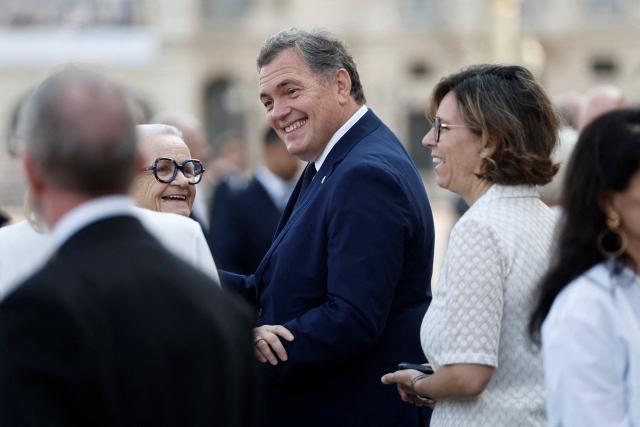 France's Transports Minister Philippe Tabarot and France's Urbanity and Decentralisation Minister Francoise Gatel arrive to attend the annual Bastille Day military parade on the Champs-Elysees Avenue in Paris on July 14, 2026. (Photo by Benoit Tessier / POOL / AFP)