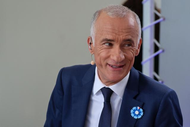 French journalist Gilles Bouleau arrives for the annual Bastille Day military parade on the Champs-Elysees Avenue in Paris on July 14, 2026. (Photo by Ludovic MARIN / AFP)