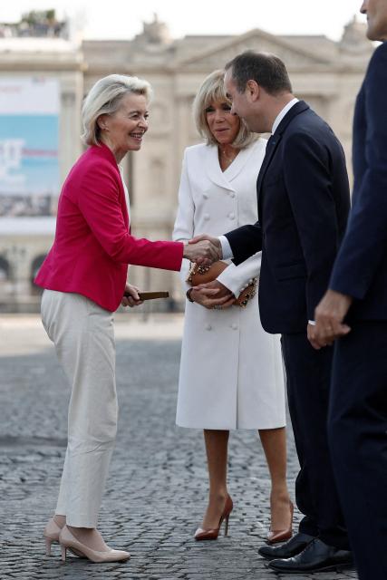 France's Prime Minister Sebastien Lecornu (R) and French President's wife Brigitte Macron (C) welcome European Commission President Ursula von der Leyen for the annual Bastille Day military parade on the Place de la Concorde in Paris on July 14, 2026. (Photo by Benoit Tessier / POOL / AFP)