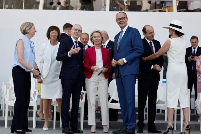 European Commission President Ursula von der Leyen (C-L), Luxembourg's Prime Minister Luc Frieden (C) and German Chancellor Friedrich Merz (C-R) attend the annual Bastille Day military parade on the Place de la Concorde in Paris on July 14, 2026. (Photo by Benoit Tessier / POOL / AFP)