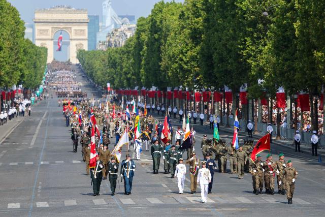 Coalition of volunteers of invited foreign nations parade during the annual Bastille Day military parade on the Champs-Elysees Avenue in Paris on July 14, 2026. (Photo by Ludovic MARIN / AFP)
