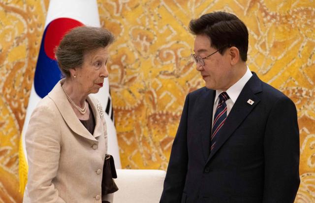 Britain's Princess Anne, the Princess Royal (L), talks with South Korean President Lee Jae Myung (R) during their meeting at the presidential Blue House in Seoul on July 14, 2026. (Photo by Heon-Kyun JEON / EPA/POOL / AFP)